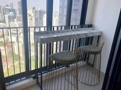 a balcony with a table and two chairs in front of a window at Ashton Mrt At Bts-Silom Near samyan mitrtown in Bangkok