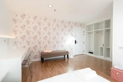 a living room with pink flowers on the wall at Modern Twin BR Bath & Bathtub Retreat BTS BTB6 in Bangkok