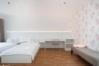 a white room with two beds and a desk at Modern Twin BR Bath & Bathtub Retreat BTS BTB6 in Bangkok