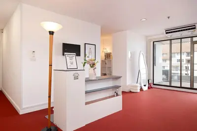 a room with a red carpet and a room with a refrigerator at Modern Twin BR Bath & Bathtub Retreat BTS BTB6 in Bangkok