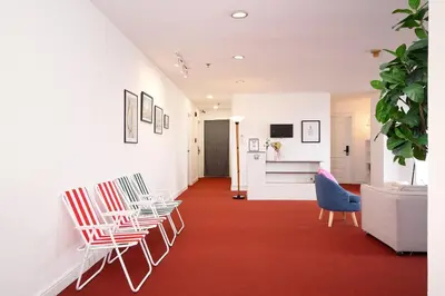 a hallway with chairs and a red carpet at Stylish Twin BR w Ensuite Bath & Relaxing Tub BTB7 in Bangkok