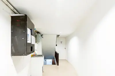 a kitchen with white walls and a white floor at xx Oh My Napz Sukhumvit 3 - สุขุมวิท ซอย 3 in Makkasan