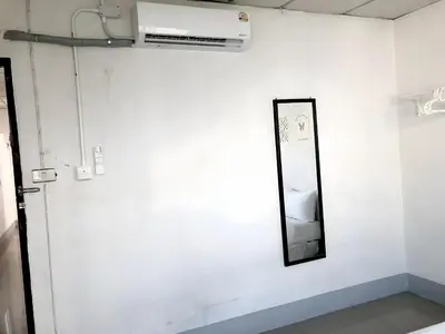 a mirror on a wall next to a white wall at xx Oh My Napz Sukhumvit 3 - สุขุมวิท ซอย 3 in Makkasan