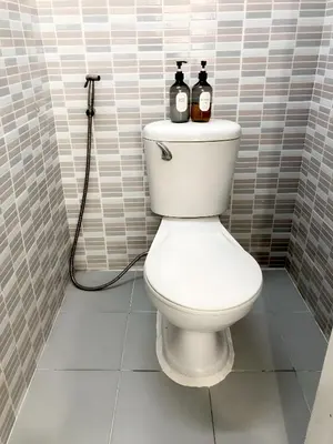 a bathroom with a toilet with two bottles on it at xx Oh My Napz Sukhumvit 3 - สุขุมวิท ซอย 3 in Makkasan
