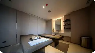 a bathroom with a bench and a sink in it at Park payathai 28 in Bangkok