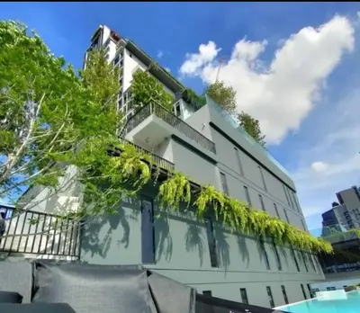 a building with plants growing on it at Park payathai 28 in Bangkok
