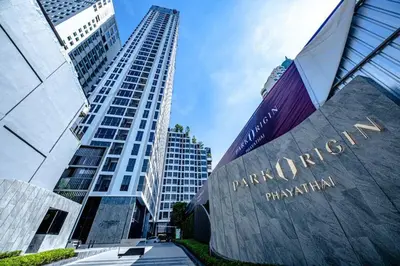 a tall building with a sign in front of it at Park payathai 28 in Bangkok