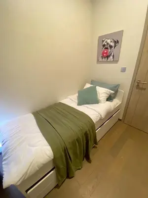 a bedroom with a bed with a dog picture on the wall at origin phayathai 28 in Bangkok