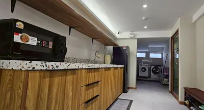 a kitchen with a counter top with a microwave at Loly Residence in Bangkok