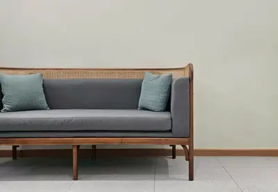a blue couch with two blue pillows on it at Loly Residence in Bangkok