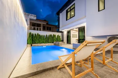 a swimming pool in the backyard of a house at SavasdeeVilla Midtown bangkok in Makkasan