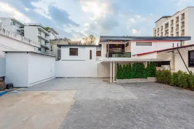 an empty parking lot in front of a house at SavasdeeVilla Midtown bangkok in Makkasan