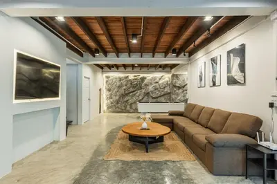 a living room with a couch and a table at SavasdeeVilla Midtown bangkok in Makkasan