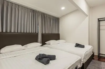 two beds sitting next to each other in a room at SwasddeeHouse midtown bangkok in Makkasan