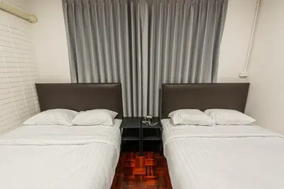 two beds sitting next to each other in a room at SwasddeeHouse midtown bangkok in Makkasan