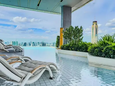 a pool on the roof of a building with a chair at New City Condo in Central Bangkok Siam Paragon Central World in Pratunam