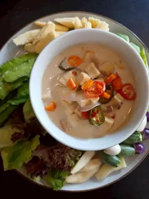 a bowl of soup with vegetables on a plate at Little Tree Hut Bangkachao in Bang Chak