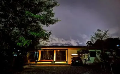 a house with a car parked in front of it at Little Tree Hut Bangkachao in Bang Chak