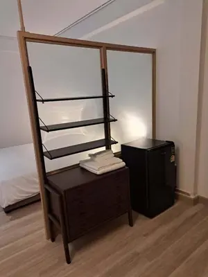 a room with a dresser and a bed and a desk at Brown H in Pom Prap