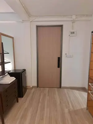 an empty room with a door and a desk at Brown H in Pom Prap