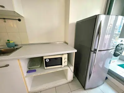 a kitchen with a stainless steel refrigerator and a microwave at Super spacious city view apartment close to King Power Mahanakhon Pixel Building Silom Road Patpong Night Market 2 minutes to BTS rail transit bourgeois lifestyle neighborhood in Bangkok