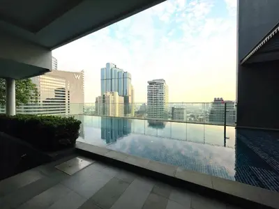 a swimming pool on the roof of a building at Super spacious city view apartment close to King Power Mahanakhon Pixel Building Silom Road Patpong Night Market 2 minutes to BTS rail transit bourgeois lifestyle neighborhood in Bangkok