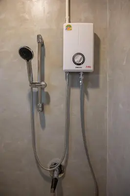 a shower with a blow dryer in a bathroom at Morning Place in Ban Krathum Lom