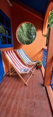 a deck with a chair on a patio at Dar Wafa Riad, Restaurant and Hamam in Bangkok