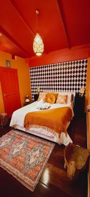 a bedroom with a king sized bed in a room at Dar Wafa Riad, Restaurant and Hamam in Bangkok