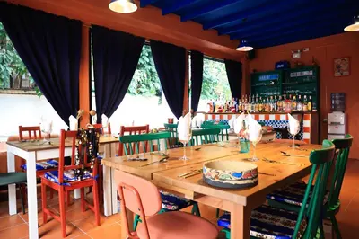 a dining room with a wooden table and chairs at Dar Wafa Riad, Restaurant and Hamam in Bangkok