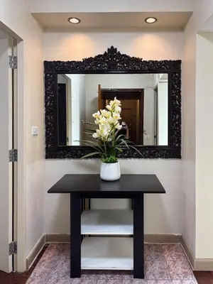 a vase of flowers on a table in front of a mirror at Bann-Kun Impact Muang Thong 2BR Condo Wi-Fi MRT Pink Near Airport DM