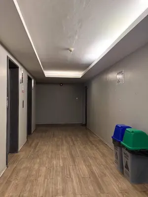 an empty room with wood floors and a white ceiling at Bann-Kun Impact Muang Thong 2BR Condo Wi-Fi MRT Pink Near Airport DM