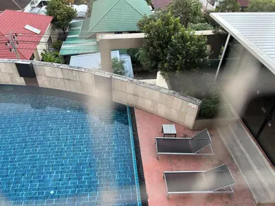 an overhead view of a swimming pool in a building at Bann-Kun Impact Muang Thong 2BR Condo Wi-Fi MRT Pink Near Airport DM