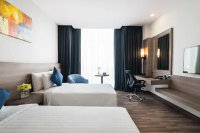 a hotel room with two beds and a desk at Best Western Plus Wanda Grand Hotel in Nonthaburi