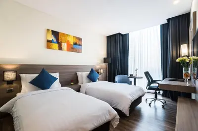 a hotel room with two beds and a desk at Best Western Plus Wanda Grand Hotel in Nonthaburi