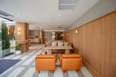 an office with a table and two orange chairs at Marwin Terra Hotel in Bangkok
