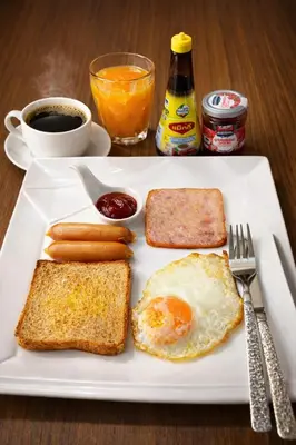 a plate of breakfast food with an egg and toast at PSA Palace Khaosan in Bangkok