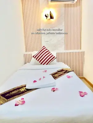 a bedroom with two beds with pink flowers on them at PSA Palace Khaosan in Bangkok