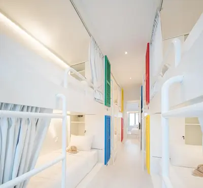 a room with white bunk beds and a corridor at Bedd Hostel in Bangkok