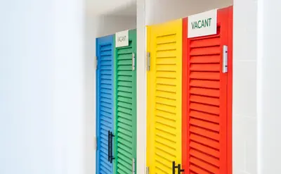 a row of colorful lockers in a room at Bedd Hostel in Bangkok
