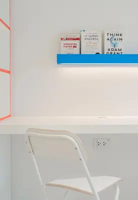 a white desk with a white chair and a shelf at Bedd Hostel in Bangkok