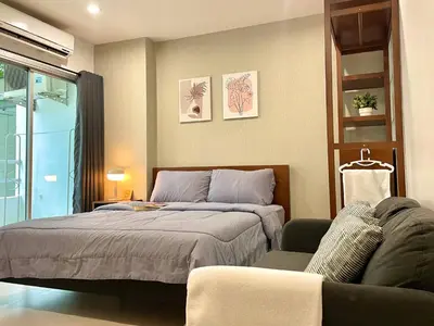 a bedroom with a bed and a couch at 1-Min Walk to BTS Thonglor Simple Spotless Great Value Stay in Khlong Toei
