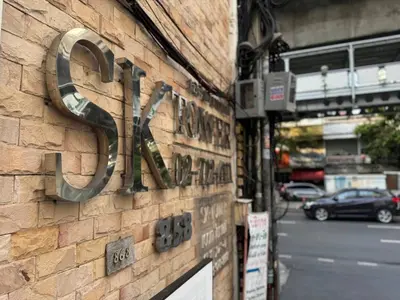 a sign on the side of a brick building at 1-Min Walk to BTS Thonglor Simple Spotless Great Value Stay in Khlong Toei