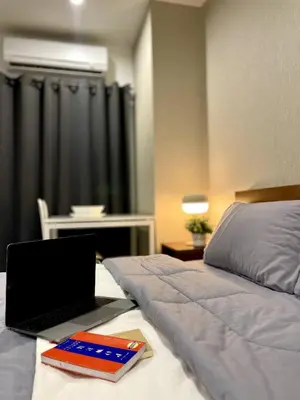a laptop computer sitting on top of a bed at Thonglor BTS 1-Min Walk Easy Check-In Laundromat in Khlong Toei