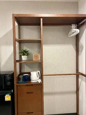a wooden book shelf with a toaster on it at Thonglor BTS 1-Min Walk Easy Check-In Laundromat in Khlong Toei