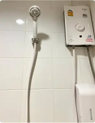 a shower in a bathroom with a blow dryer at Thonglor BTS 1-Min Walk Easy Check-In Laundromat in Khlong Toei