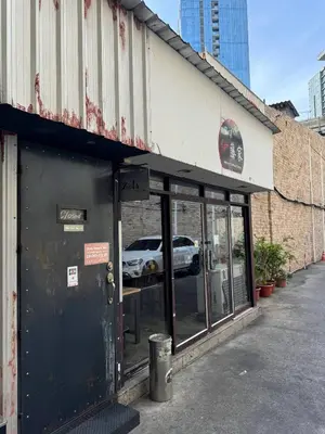 a store front of a building with a car in the window at Thonglor BTS 1-Min Walk Easy Check-In Laundromat in Khlong Toei