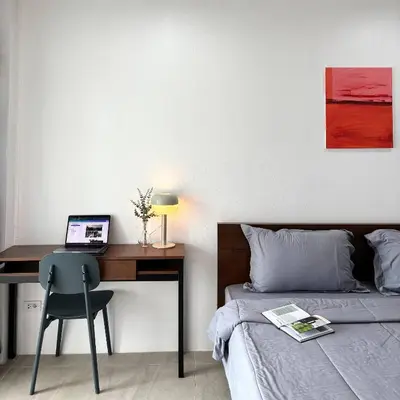 a bedroom with a bed and a desk with a laptop at 1minBTS-Wifi500Mbs-Workplace>NETFLIX/Central in Khlong Toei