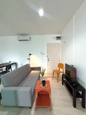 a living room with a couch and a table at 1minBTS-Wifi500Mbs-Workplace>NETFLIX/Central in Khlong Toei