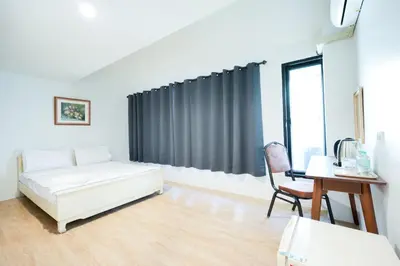 a white room with a bed and a desk and a chair at XX Snap Sukhumvit 1 -BTS Nana Bangkok in Makkasan